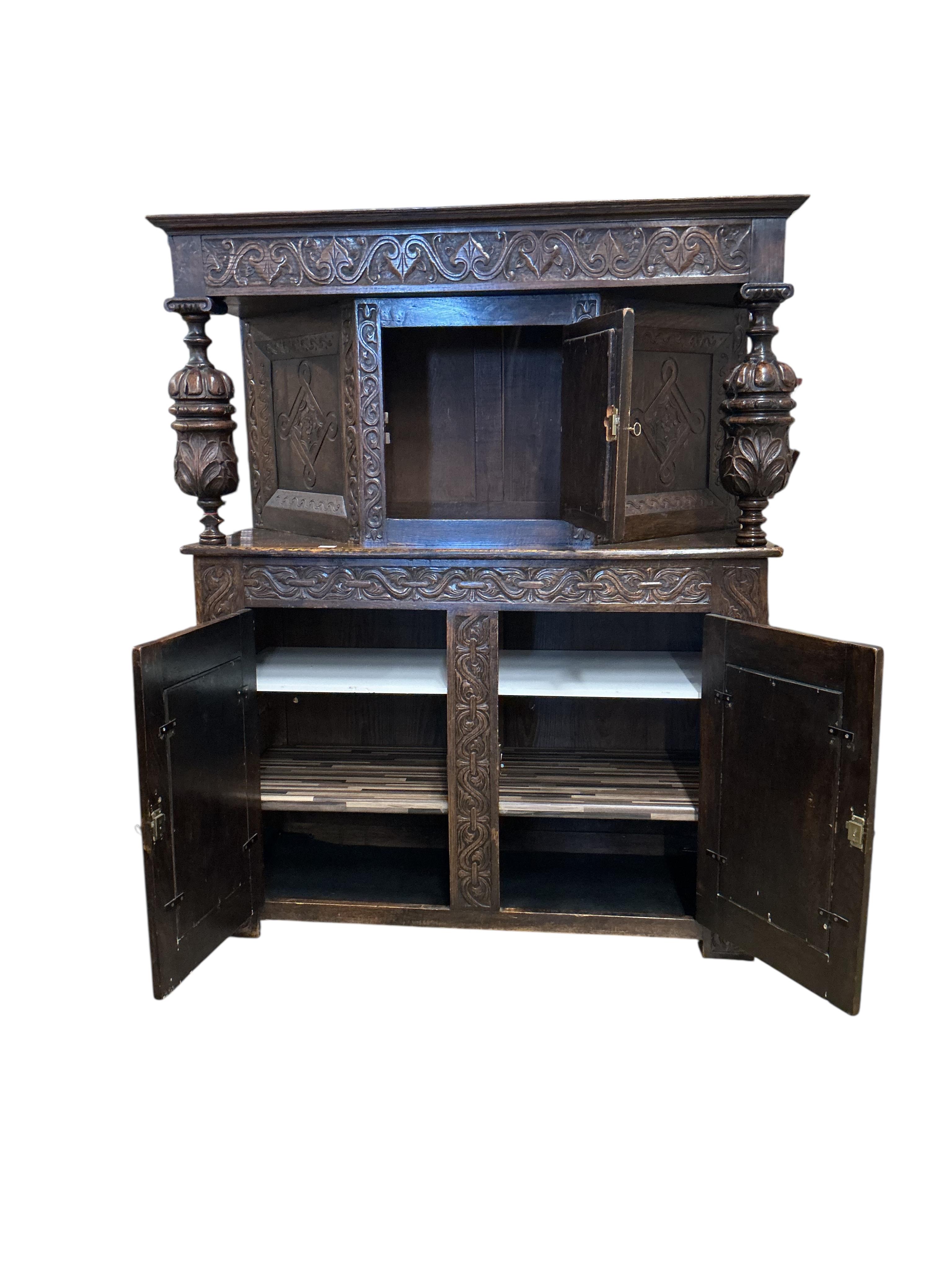 A 17th century style carved oak court cupboard, width 142cm, depth 53cm, height 176cm